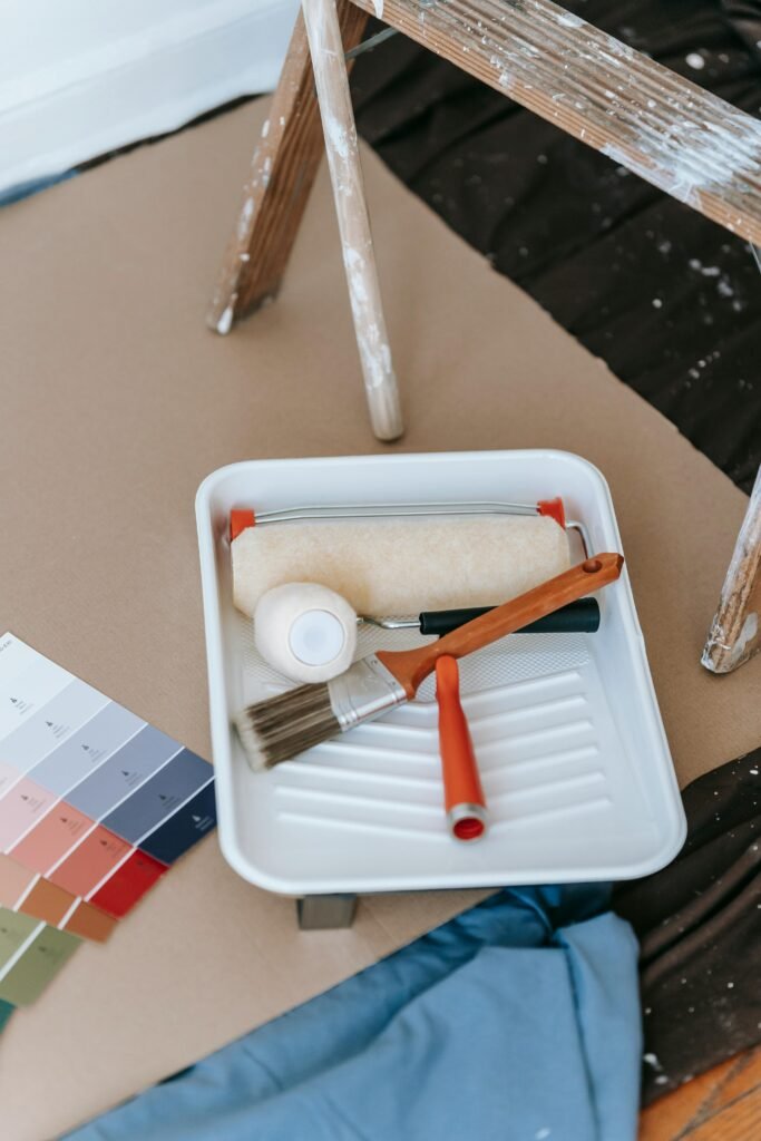 A well-organized setup for a DIY home painting project, complete with tools and color swatches.