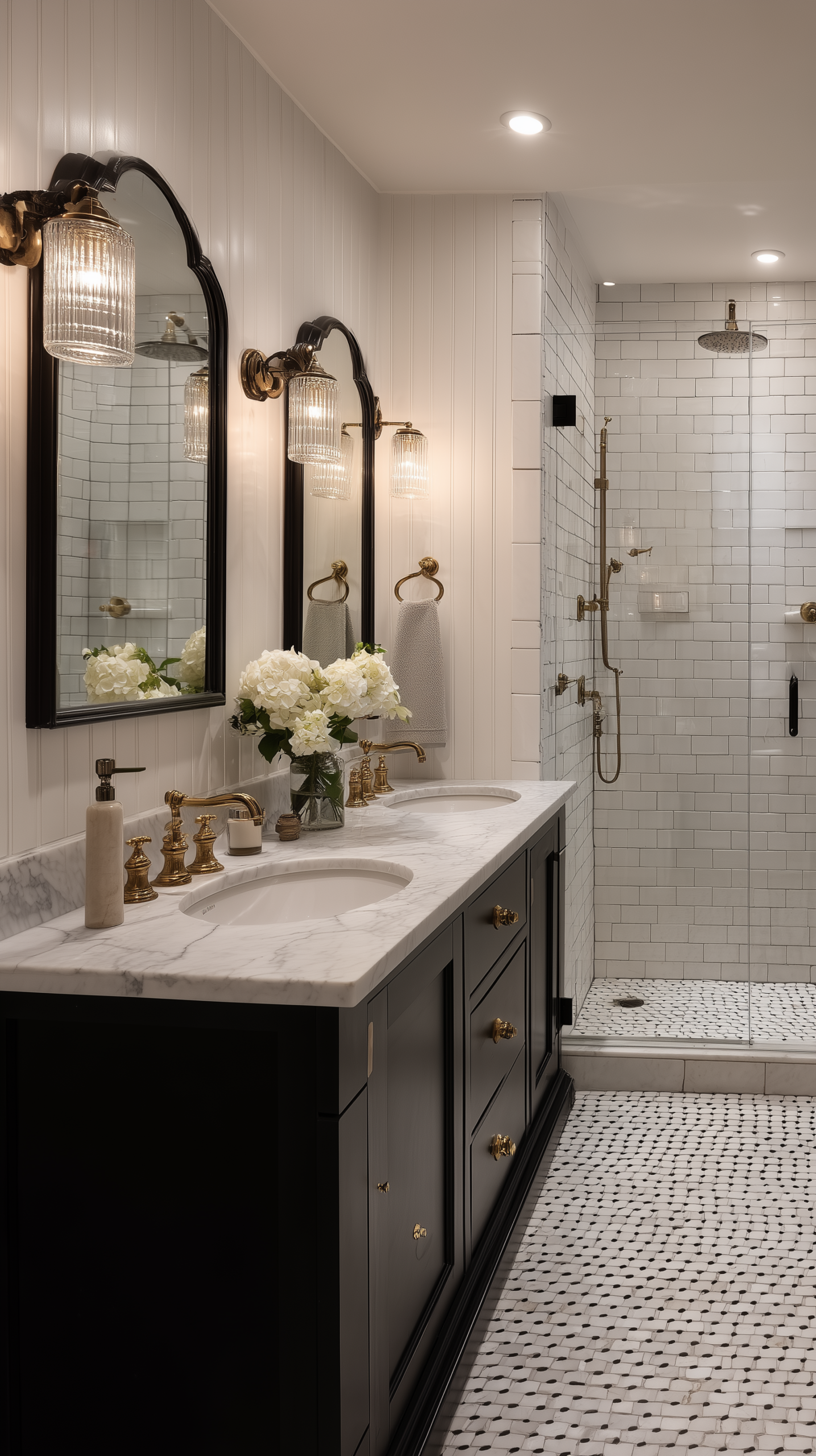 Black and white farmhouse bathroom with marble hex tile, beadboard, matte black vanity, and brass fixtures